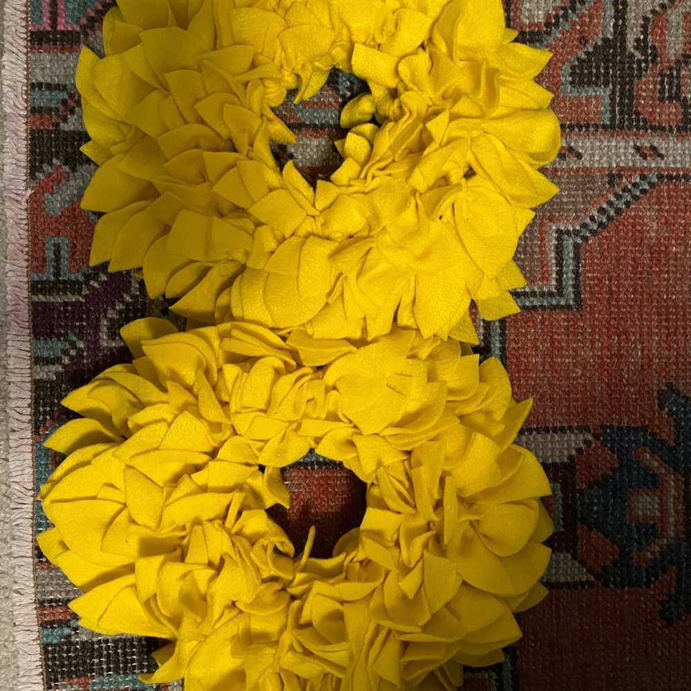Pair of handmade yellow felt wreaths. Bought off of Etsy.
